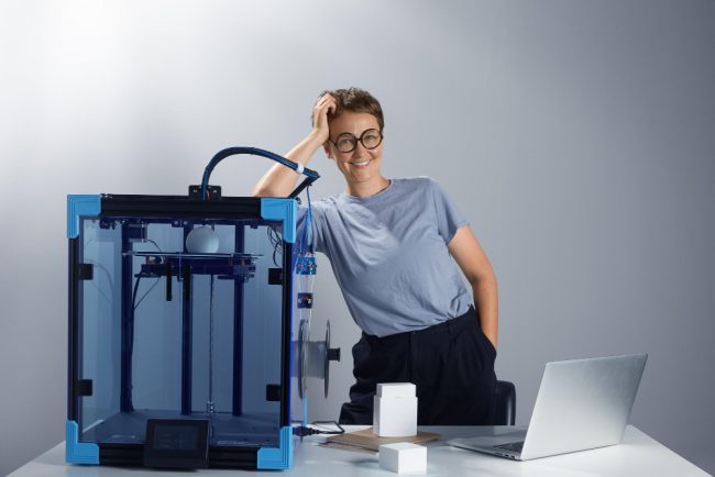 caucasian-beautiful-lady-in-the-glasses-smiling-near-3d-printing-machine-in-her-office-new-technologies-for-small-businesses-concept-computer-prototypes-on-the-table-tech-ambient-jpg-photo (2) (1)